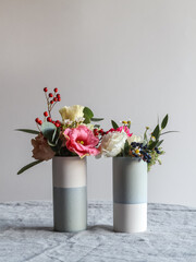 Colorful tiny bouquets in two vases with a copy space