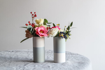 Colorful tiny bouquets in two vases with a copy space