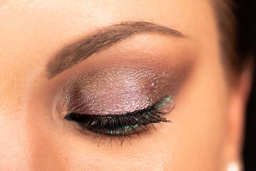 Close up of woman face with amazing make-up, eye with glitter shadows. Art, beauty industry,...