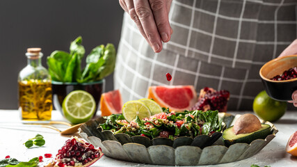 Freezer food prepare in process vegan winter salad by chef hand in home kitchen with quinoa,...