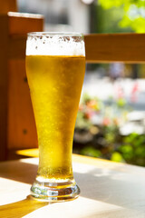 A glass of light beer in the pub on the sun terrace.