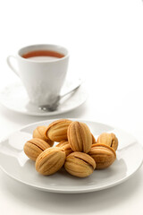 Close up view of dessert plate and china cup on white background