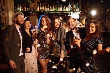 Confetti party. Have fun together. Group of happy people throwing confetti while enjoying party....