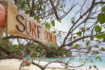 Close up view of surfing school sign on tropic beach