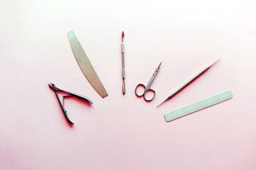 Professional set for manicure on a pink background.