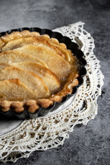 Small homemade apple pie on rustic background