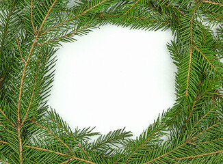 Frame of traditional natural green Christmas branches on white background. Top view with copy space for text, gifts and toys.