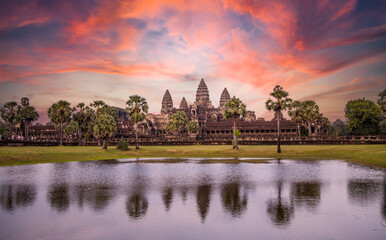 Fototapeta na wymiar Angkor Wat main temple reflected in the water in a beautiful summer sunrise. Cambodia