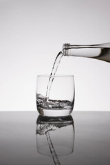 .glass of water, bottle of water, empty glass