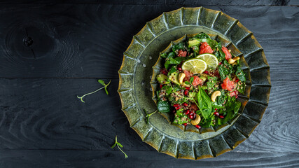 Avocado, quinoa, spinach, grapefruit, pomegranate, nuts and microgreens salad Rustic style. Top view. space for text