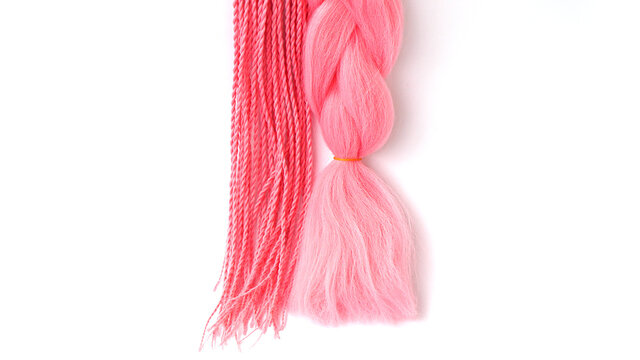 Pink kanekalon hangs and braids on a white background. Photo for catalog or hairdresser