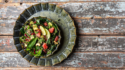 Obraz na płótnie Canvas Spinach salad with quinoa, grapefruit, pomegranate, microgreens and avocado. Clean eating, vegan food. Long banner format. space for text