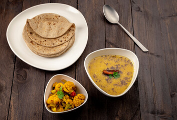 traditional indian meal lentil soup, flat bread and cauliflower vegetable, dal, roti and sabzi