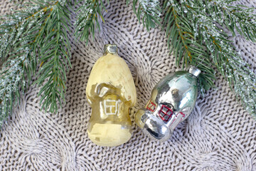 Old soviet decoration on the Christmas tree, glass toy tiny houses close up on knitted background