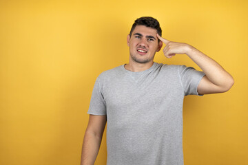 Young handsome man wearing a casual t-shirt over isolated yellow background having an idea