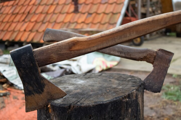 Two axes stuck in a large stump on the street