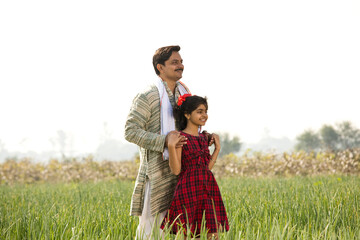 Happy Indian father and daughter in agricultural field
