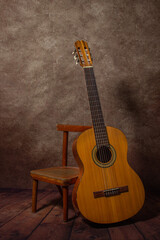 Naklejka premium Acoustic guitar on a stool. Musical instrument. Spanish guitar.