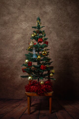 Christmas tree on a stool. Christmas concept. An elegant tree. country style. Little christmas tree