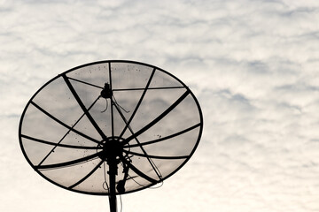 Satellite dishes have a sky background.