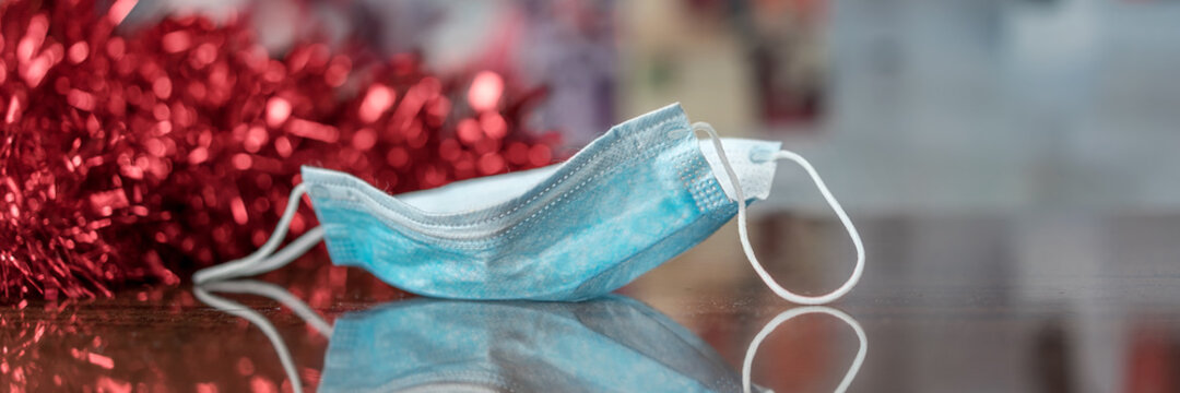 Medical protective facemask blue colour located on wooden table surface during Christmas or new year holiday