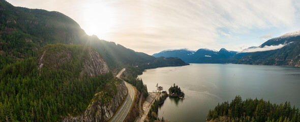 Sea to Sky Hwy in Howe Sound near Squamish, British Columbia, Canada. Aerial panoramic View. Beautiful Sunny and Cloudy Morning Sky.