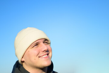 Happy young man enjoying the autumn sunshine