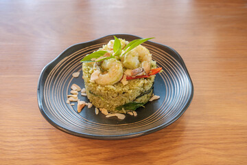 Shrimp pesto rice in white plate on wooden table. enjoy eating concept.