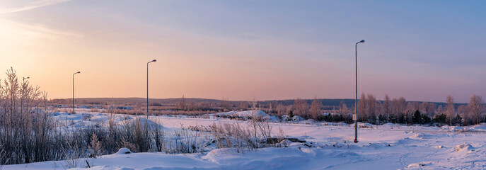 dawn on a snow-covered field amid grass 3