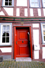 Fototapeta na wymiar old wooden door entrance to the house, concept of the beginning of a new life, magic portal, medieval European architecture, history of cities