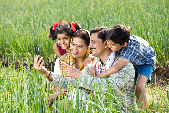 Rural family taking selfie using mobile phone on agriculture field