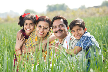 Rural family of farmer on agriculture field