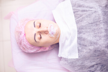 The girl's face during a facial rejuvenation procedure.