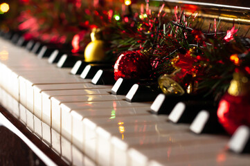 Keys of the instrument decorated with balls, the Concept of new year and Christmas