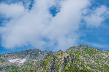 Fototapeta na wymiar Blue sky and clouds over the rocks, beautiful cloud landscape over mountain range