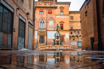 Neptune fountain Bologna, Italy - medieval bricks town with archs. Sunrise moment 