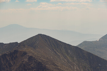 Panoramic view of mountain ranges. Rock ridge with various peaks for rock climbing