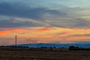 Obraz premium High voltage pylon in the countryside at sunset
