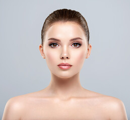 Front portrait of a white young woman with beauty face - isolated. Skin care concept.