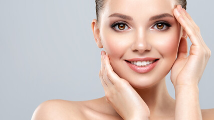 Beautiful face of young smiling woman with clean fresh skin - isolated.  Young white happy woman with a clean skin.