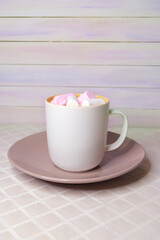 Fototapeta na wymiar A Cup of coffee with foam and marshmallows. Beige, calm and warm tones. Perfect breakfast. Space for text.