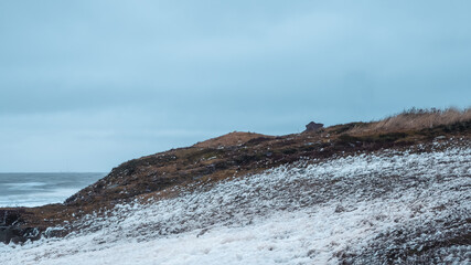 White sea foam on the shore. Storm on the White sea, dramatic landscape with waves rolling on the shore