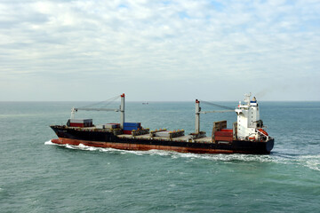 Container ship departing port of Xiamen, China. 