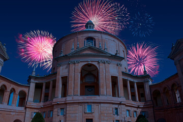 Celebratory fireworks for new year over San Luca Basilica or cathedral or church during last night of year. Christmas atmosphere. Bologna - Emilia - Romagna, Italy  © Giampaolo