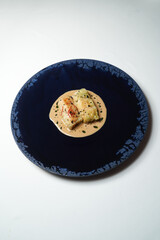 Stuffed cabbage on a blue plate on white background