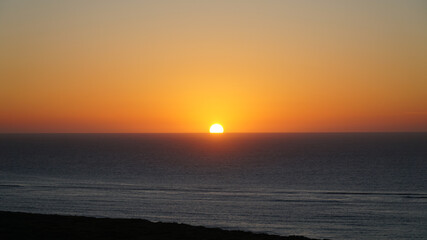 Sunset over the ocean seen from the Thomas Carter Lookout near Exmouth, Western Australia.