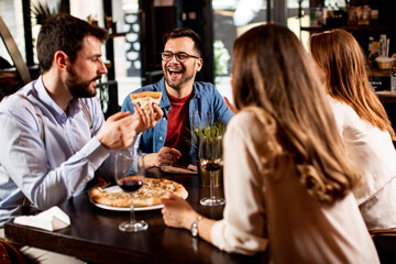 Young people having dinner in the restaurant