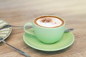 Green Cup Of Coffee Latte On Wooden Background, Close Up Of Art Coffee In Morning.