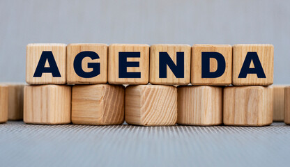 AGENDA - word on wooden cubes on a beautiful gray background