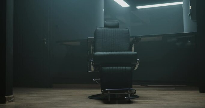 Barbershop room with two working places in the beauty salon. Hair salon interior. Empty chairs in styled barbershop. Chairs and mirrors in modern hairdressing. Interior of a modern hair salon